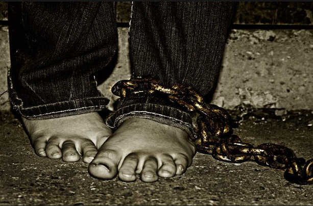 a leg tied with a chain showing exploitation