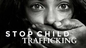 an adult hand closing a girl child's mouth with a text written stop child trafficking 