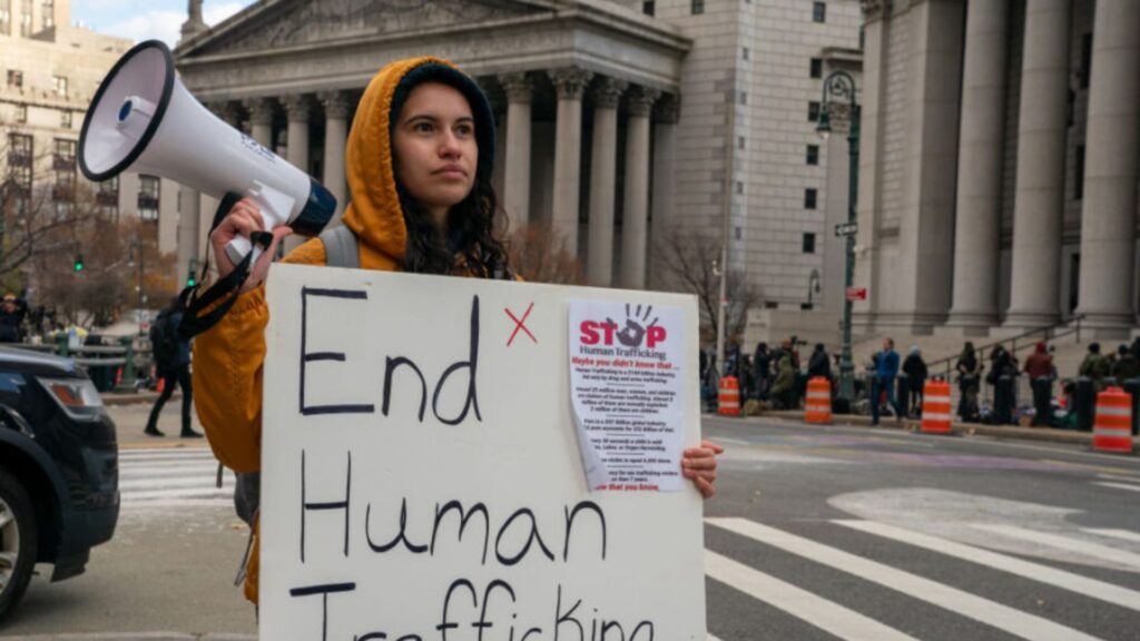 a young lady holding a poster showing youth engagement in anti-human trafficking activism