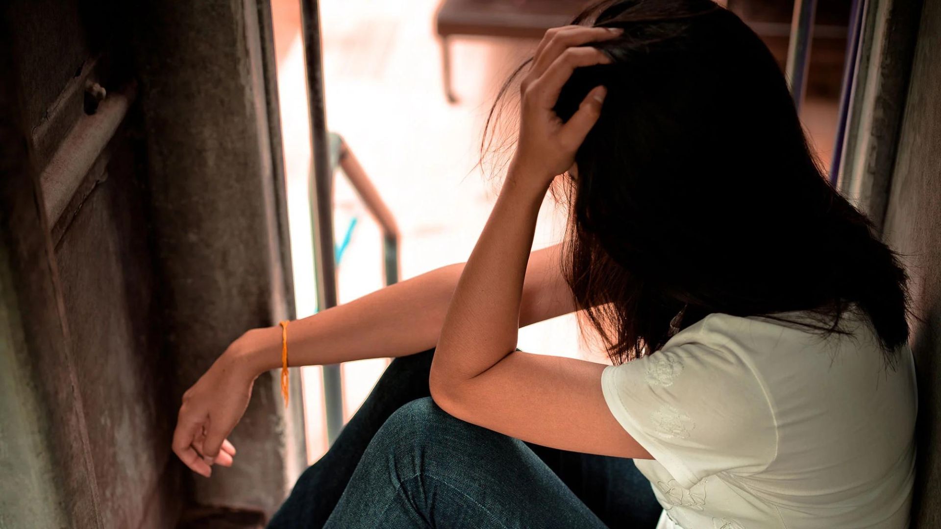 A Young Lady Sitting While Looking Sad Showing How Do Human Trafficking Victims Recover