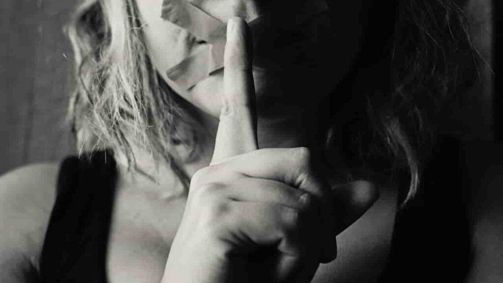 A Young Girls Putting Her Finger On Her Mouth Showing The Ways To Prevent Child Trafficking